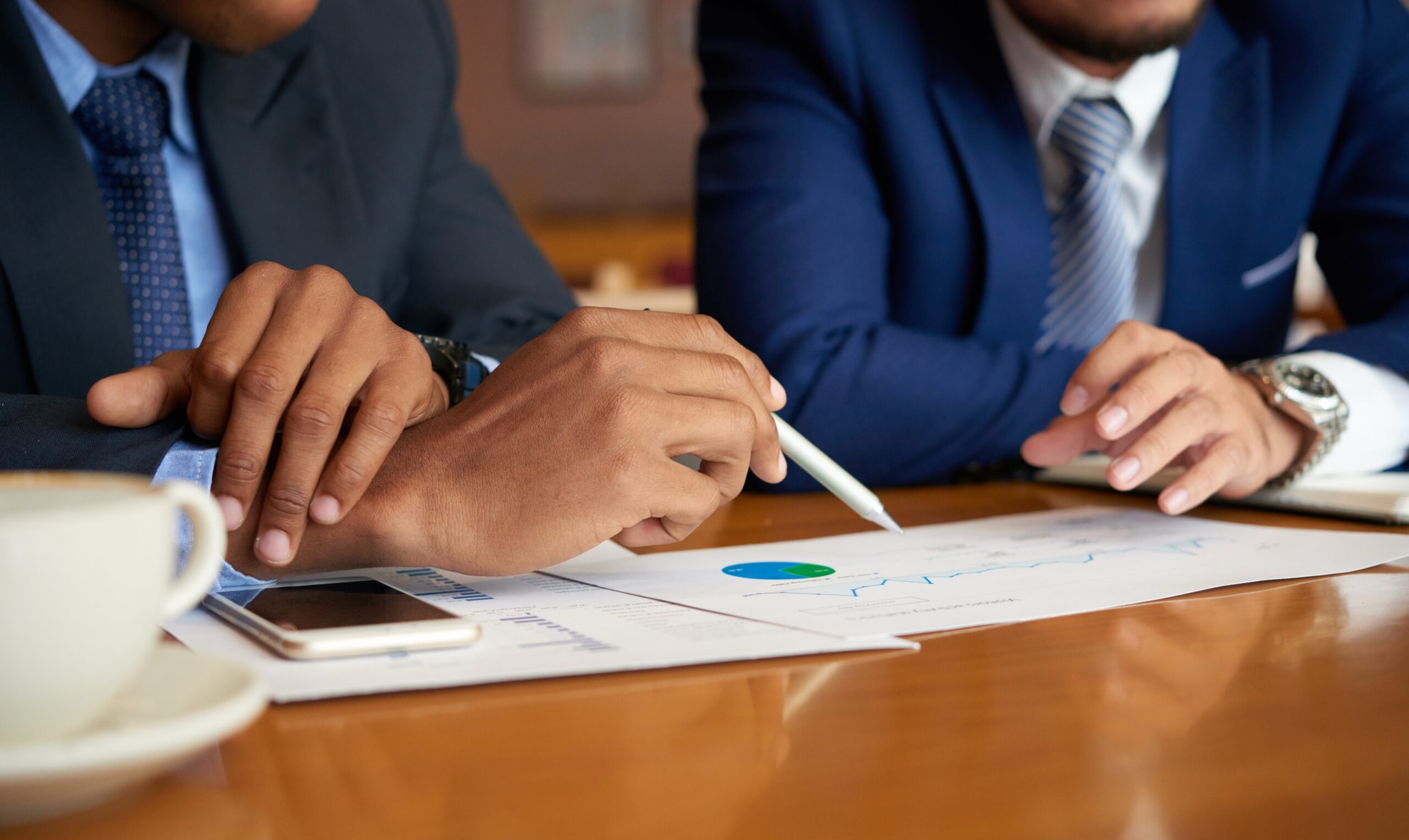 close up image of business people discussing financial data at meeting